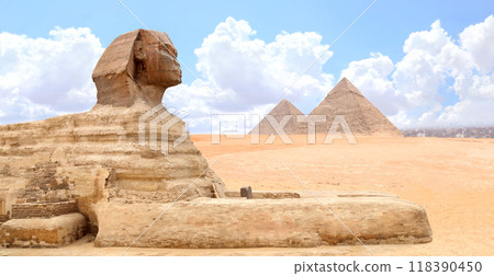 Famous Great Sphinx and pyramids of Chephren and Cheops, Cairo, Egypt. Great Pyramids and ancient statue of Sphinx, mythical creature with head of man and body of lion, Giza complex (Giza Necropolis) 118390450