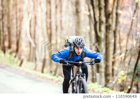 Active man on bike in the middle of beautiful nature, early autumn morning. Concept of healthy lifestyle. Active man on bike in the middle of beautiful nature, early autumn morning. Concept of healthy lifestyle. 118390649