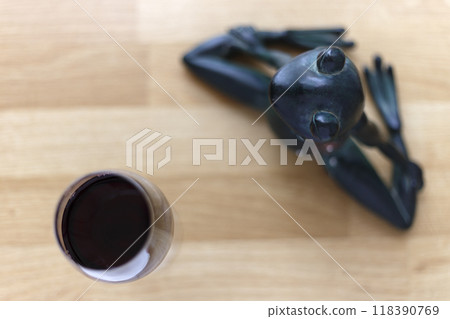 Toy frog meditating with wine 118390769