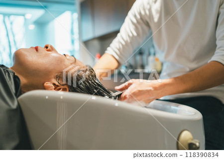 Adult woman shampooing at a beauty salon Adult woman shampooing at a beauty salon 118390834
