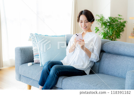 中間女人在房間裡操作智能手機 118391182
