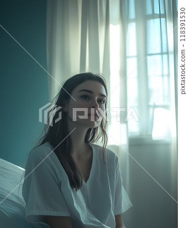 Young woman in sunlight by hospital window 118391530
