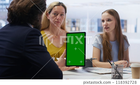 People receiving personalized financial plan from financial advisor using isolated screen tablet. Customers learn how to make profitable decisions from agent using chroma key device, camera B People receiving personalized financial plan from financial advisor using isolated screen tablet. Customers learn how to make profitable decisions from agent using chroma key device, camera B 118392728
