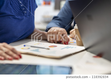 Senior man supporting his wife while they explore retirement plans with a broker, discussing future investment to secure pension and life savings. Professional insurance counseling. 118392834