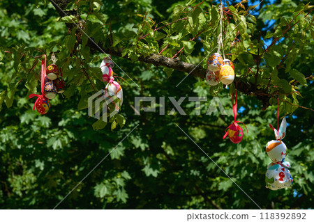 Bouquet of colorful painted Easter eggs on green spring tree Bouquet of colorful painted Easter eggs on green spring tree 118392892