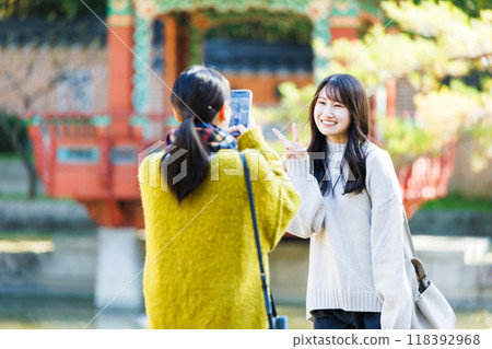 A woman taking a picture with a smartphone A woman taking a picture with a smartphone 118392968