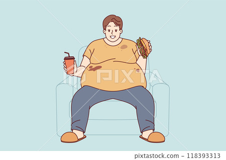 Fat man suffers from obesity caused by problem of overeating, sitting on sofa with burger and soda Fat man suffers from obesity caused by problem of overeating, sitting on sofa with burger and soda 118393313