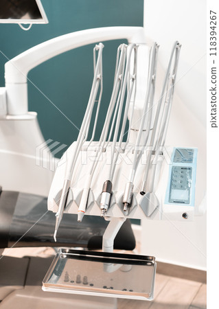 Silence and cleanliness in the dental office, where an empty table for instruments and sterilization means indicate readiness to receive patients. 118394267