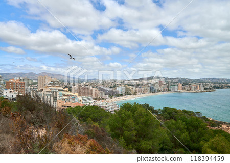 Majestic Cliffside Perspective Calpe Spain Azure Sea Pristine Beaches Penon de Ifach Natural Vegetation Sunny Tourism Hotspot. Picturesque Mediterranean Seascape Calpe Cliffs Crystal Clear Waters 118394459