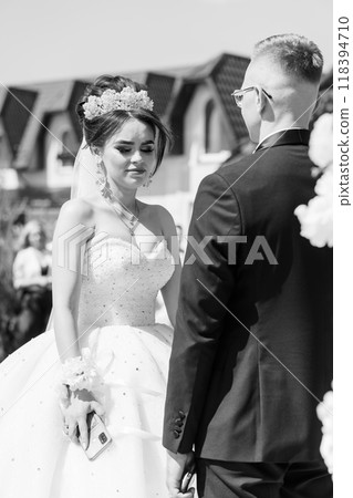 Elegant Outdoor Black and White Wedding Ceremony with Bride and Groom Sharing a Heartfelt Moment Elegant Outdoor Black and White Wedding Ceremony with Bride and Groom Sharing a Heartfelt Moment 118394710