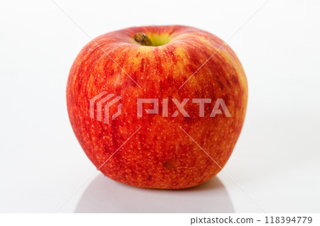 Closeup of ripe organic red apple on white table background. Selective focus. Closeup of ripe organic red apple on white table background. Selective focus. 118394779
