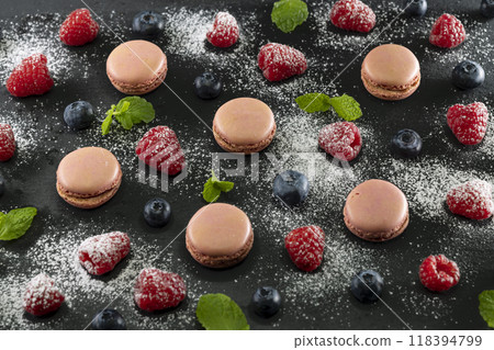 macaroons of different colors on a black background macaroons of different colors on a black background 118394799