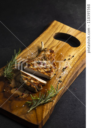 pork cutlet with a bone on rosemary and pepper 118395568