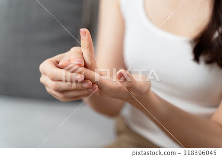 A woman is wiping her hands with a paper towel A woman is wiping her hands with a paper towel 118396045