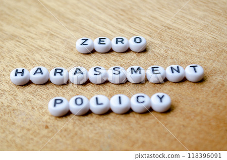 Zero Harassment Policy Text on white button on wooden table Zero Harassment Policy Text on white button on wooden table 118396091