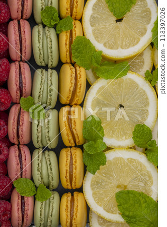macaroons of different colors with with raspberries, lemon and mint macaroons of different colors with with raspberries, lemon and mint 118397026