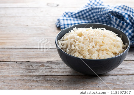 Sauerkraut in a bowl on wooden table. Traditional german food Sauerkraut in a bowl on wooden table. Traditional german food 118397267