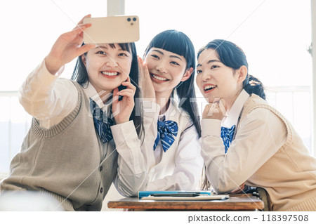 High school girls taking photos with their friends High school girls taking photos with their friends 118397508