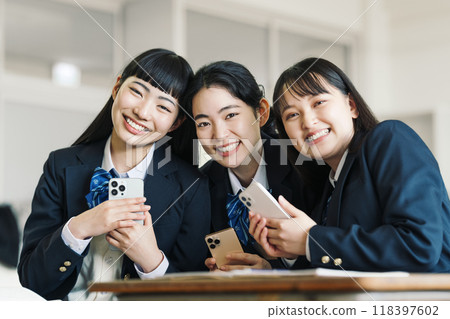 High school girl with a smartphone at school High school girl with a smartphone at school 118397602