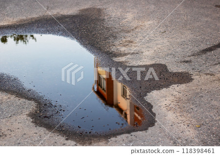 A beautiful house is vividly reflected in a puddle of water A beautiful house is vividly reflected in a puddle of water 118398461