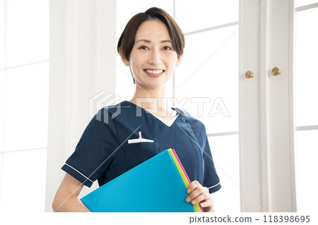 Middle-aged female staff member holding a binder 118398695