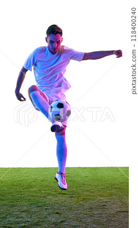 Athletic young man practicing ball control. With focused intensity, he perfecting his dribbling skills on field in neon light. Athletic young man practicing ball control. With focused intensity, he perfecting his dribbling skills on field in neon light. 118400240