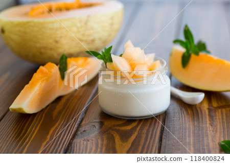 sweet homemade yogurt in a jar with pieces of ripe melon 118400824