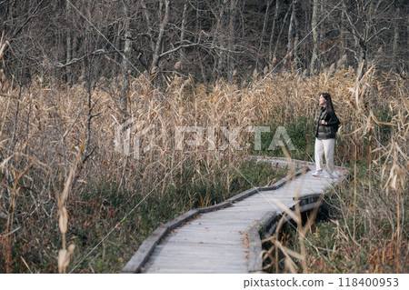 Embrace the joy of solo travel as an Asian woman hikes through Japan's fall terrain, finding peace and beauty along the way. 118400953