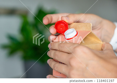 Long-life cardboard container from recycling materials with stationary plastic cap. Cap remains attached after opening, making the entire package easier to collect and recycle Long-life cardboard container from recycling materials with stationary plastic cap. Cap remains attached after opening, making the entire package easier to collect and recycle 118401197