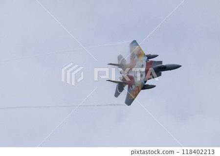 A fighter plane making a sharp turn 118402213