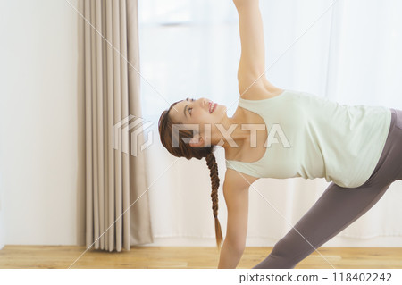 A young woman showing poses in an online yoga salon A young woman showing poses in an online yoga salon 118402242