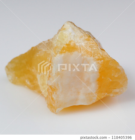 Elegant Close-Up of Natural Yellow Calcite Stone on White Background 118405396