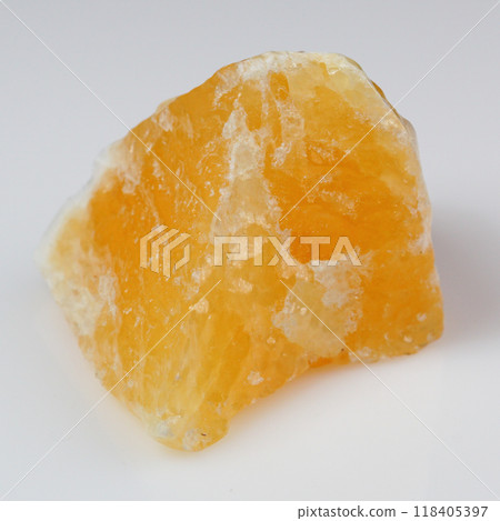 Enchanting Raw Yellow Calcite Crystal on Pristine White Background for Stock Photography Enchanting Raw Yellow Calcite Crystal on Pristine White Background for Stock Photography 118405397