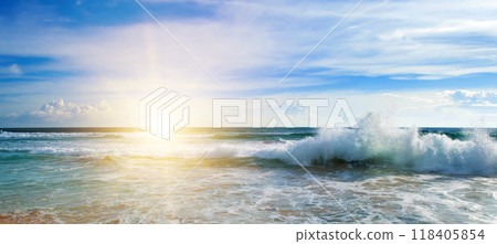 Sea and bright sun on blue cloudy sky. Sea and bright sun on blue cloudy sky. 118405854