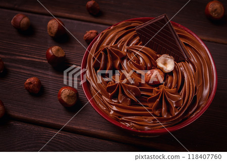 Chocolate nut paste, mousse, pasta, in a cup, on a wooden table, top view, selective focus, no people, Chocolate nut paste, mousse, pasta, in a cup, on a wooden table, top view, selective focus, no people, 118407760