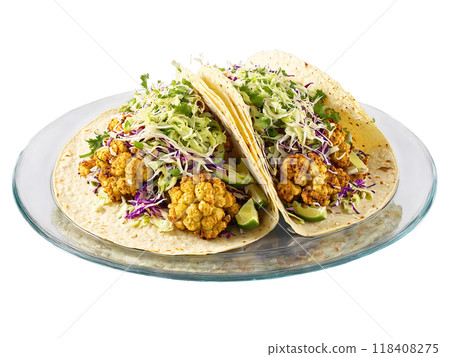 Roasted Cauliflower Tacos with chipotle sauce and slaw served on a transparent glass plate vegetarian Roasted Cauliflower Tacos with chipotle sauce and slaw served on a transparent glass plate vegetarian 118408275