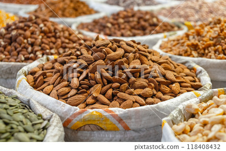 A bag of almonds among other nuts and seeds  118408432