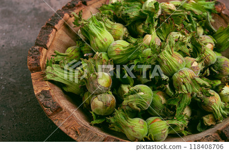 Fresh, green hazelnuts, close-up, in a wooden bowl, unpeeled, top view, no people, 118408706