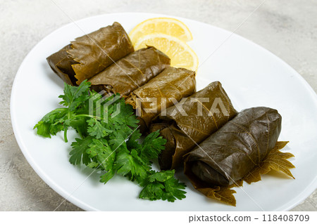 dolma, minced meat with rice, in grape leaves, rolls with minced meat, on a white plate, top view, no people, dolma, grape leaves with filling, 118408709