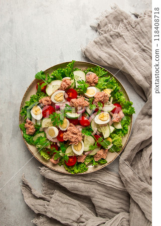 Tuna salad, vegetable salad with quail eggs, lettuce, red onion and cucumbers, on a light gray table, keto food, lifestyle, healthy eating, selective focus, top view, no people, 118408718