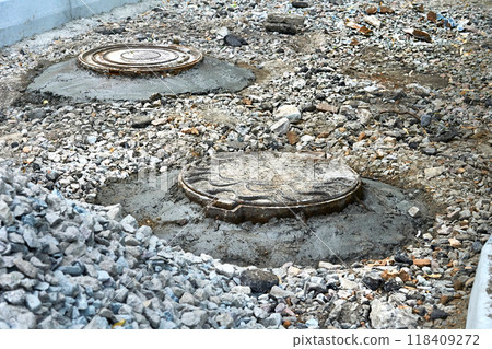 Road repair. Sewer manholes covered with cement mortar 118409272
