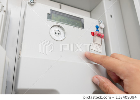 Man checking household electricity meter Man checking household electricity meter 118409394