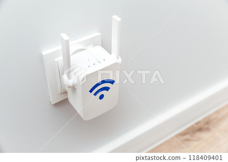 Wireless Wi-Fi repeater on white wall indoors 118409401
