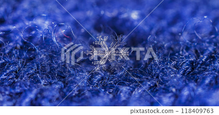 natural snowflakes on a knitted mitten 118409763