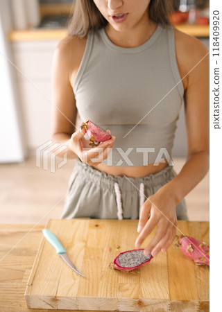 The preparation of fresh and vibrant Dragon Fruit in a bright, inviting kitchen setting 118409920