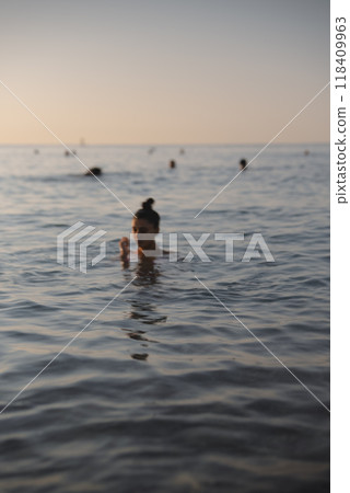 Experience the Serene Evening Swim in the Calm Waters of a Beautiful Tropical Ocean Experience the Serene Evening Swim in the Calm Waters of a Beautiful Tropical Ocean 118409963