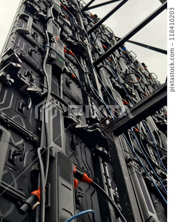 A bunch of electrical wires and connectors are hanging down from a led panel A bunch of electrical wires and connectors are hanging down from a led panel 118410203