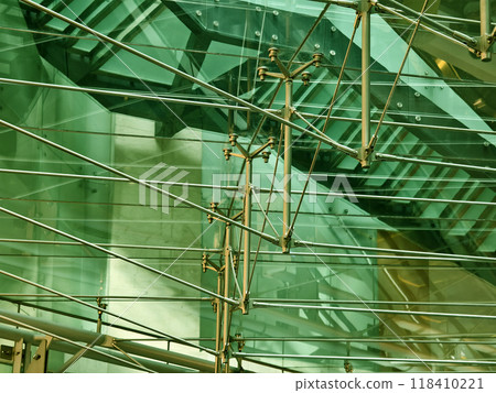 A modern tall building that features a significant amount of glass 118410221