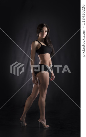 Beautiful athletic girl on a dark background 118410226