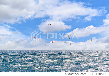 People practicing kitesurfing on the beach of Los Canos de Meca, next to the Trafalgar Lighthouse, Barbate, Cadiz 118410563